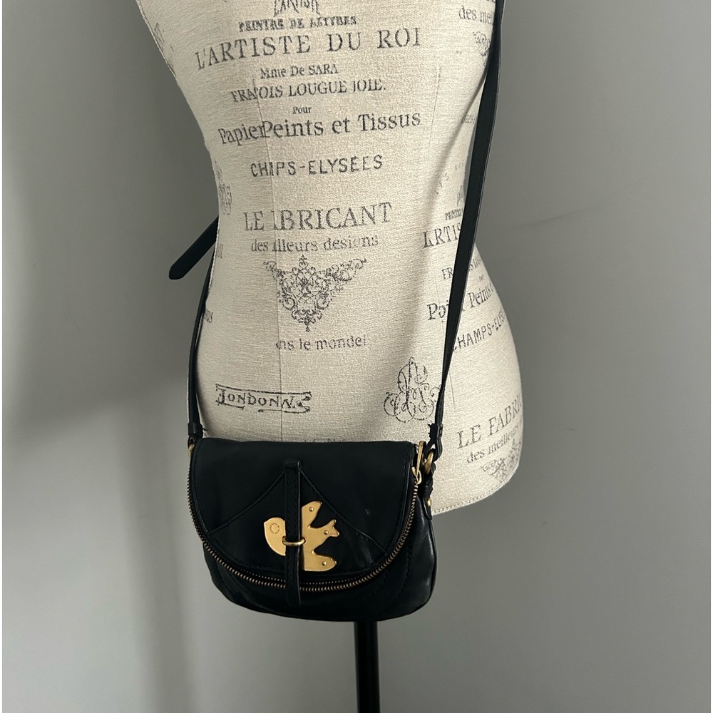 Leather cross body bag with outside pocket with pretty fabric lining.
